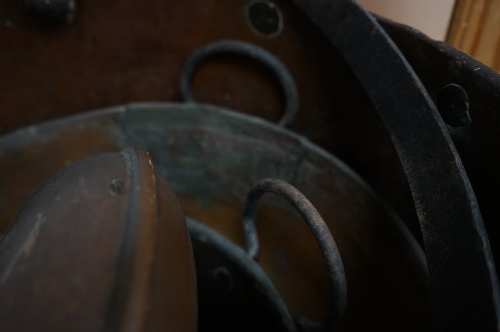 Four copper pans and a copper warming vessel